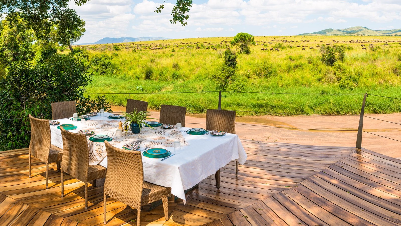 Open-air dining deck at a Mara conservancy camp overlooking the plains