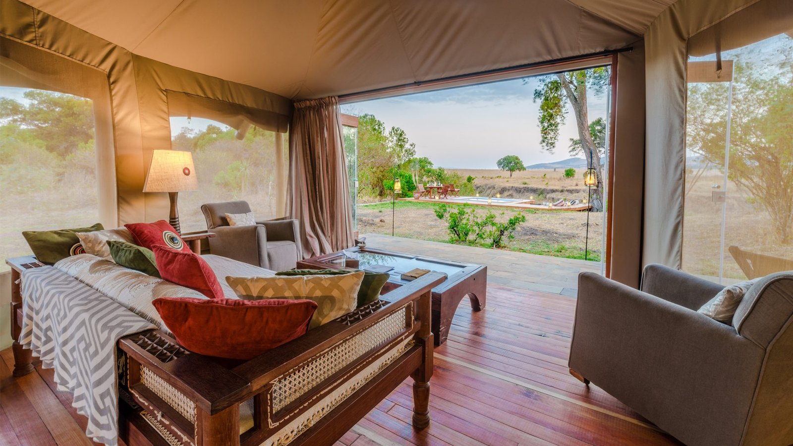 Open-plan luxury tented suite with lounge area and private terrace